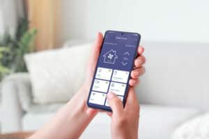 Mobile phone, showcasing a smart home app, HVAC Technology in 2025.