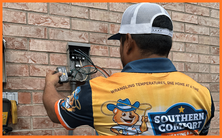 HVAC technician wearing Southern Comfort Heating & Air shirt working on outdoor HVAC unit.